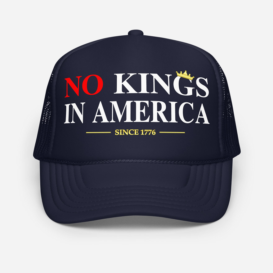 Front of No Kings In America navy foam trucker hat showing large script design printed in red and white font.