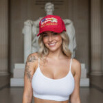 Front of Real Patriot USA Flag Eagle black foam trucker hat on blonde girl showing printed flag, eagle, Real Patriot design.